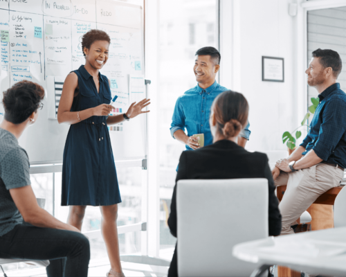 Work day in which 5 people debate in front of a blackboard