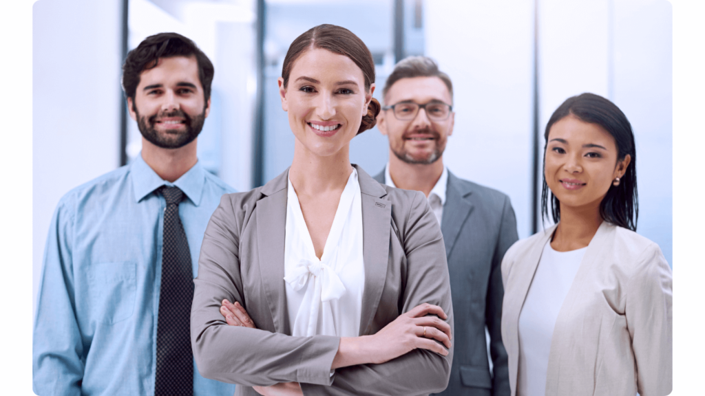 three managerial people look at the camera and smile in suits